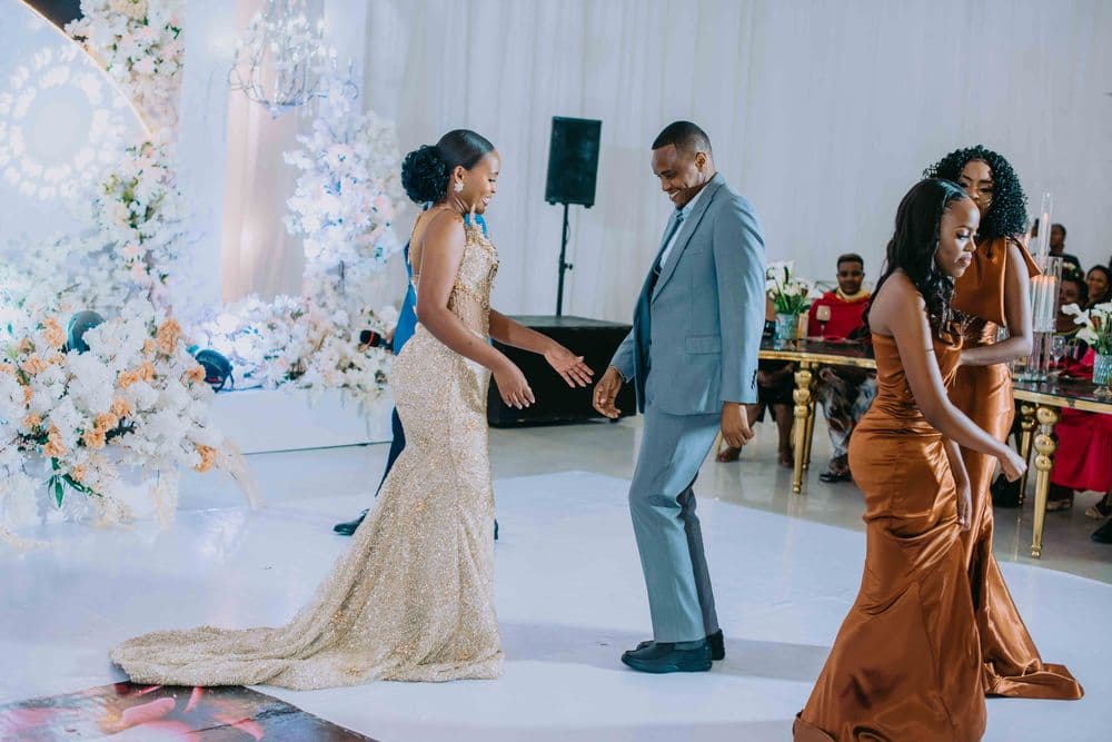 A couple and their guests dancing at a wedding reception